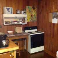 Fully equipped kitchen - stove, fridge, microwave, coffee maker, plates, cups, utensils, pots and pans.
