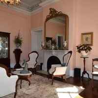 Formal Parlor - in addition to the grand fireplace, parlor seating and marble bistro tables for intimate talks or dining, guests will find a display of James K. Polk presidential china. 