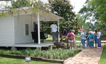 A group of Elvis fans visiting his birthplace home.